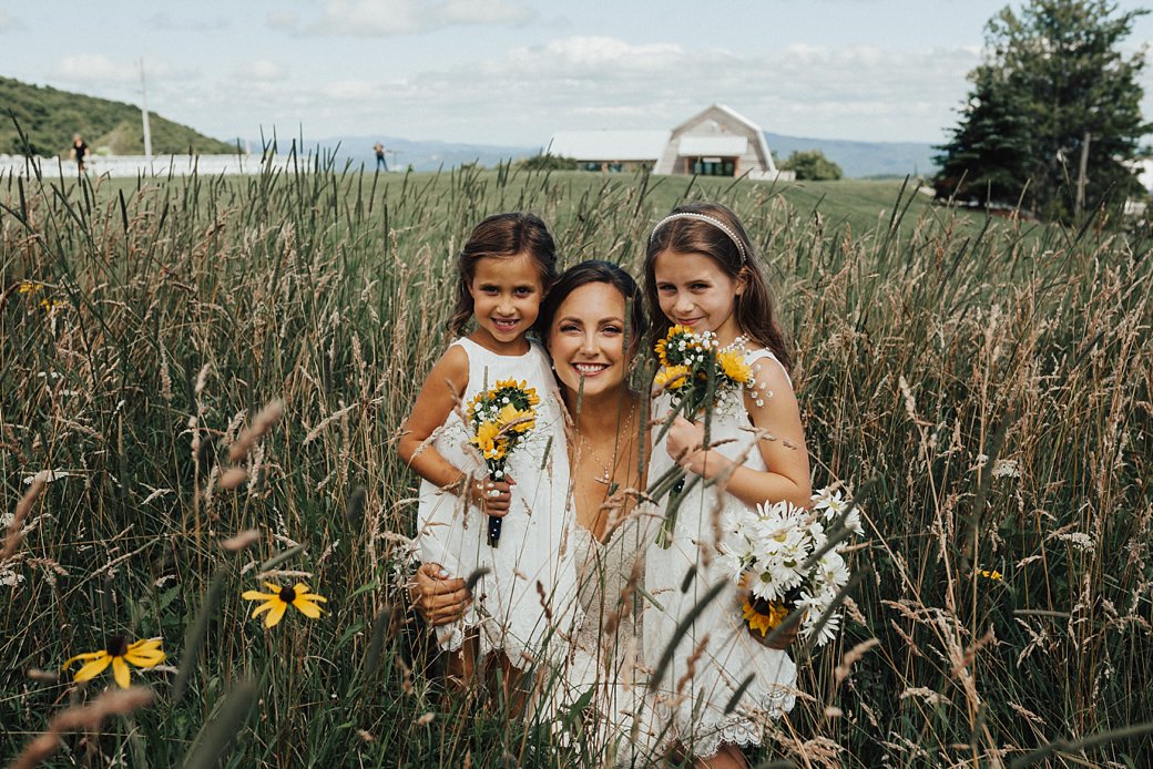 Bride standing with two flowergirls 