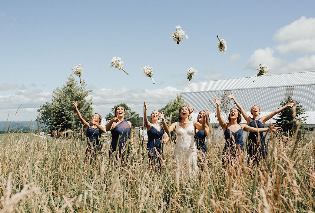 Hadley and bridesmaids throwing bouquets in the air 