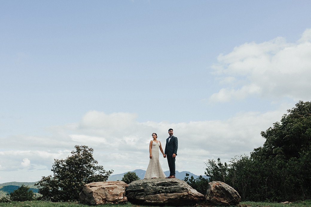 Hadley and Cliff standing on rock at Overlook Barn Wedding 