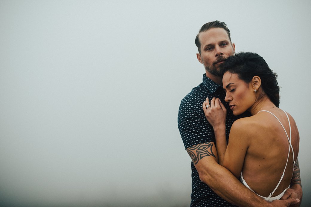 Guy with arms wrapped around fiance on top of Black Balsam Knob 