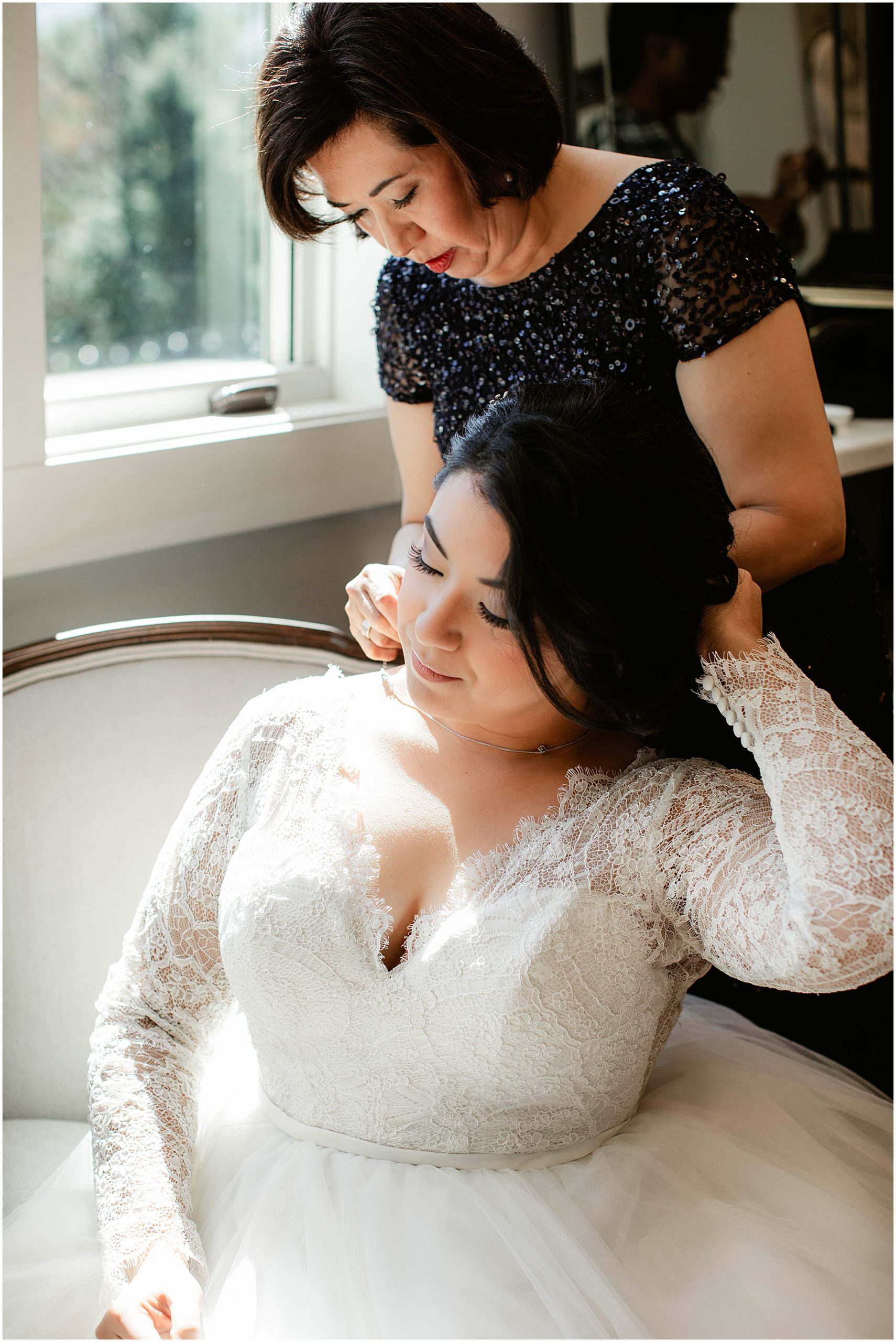 bride's mom putting on her necklace at nc wedding