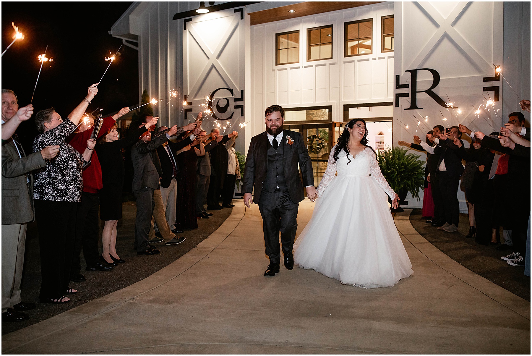 bride and groom leaving wedding during sparkler exit