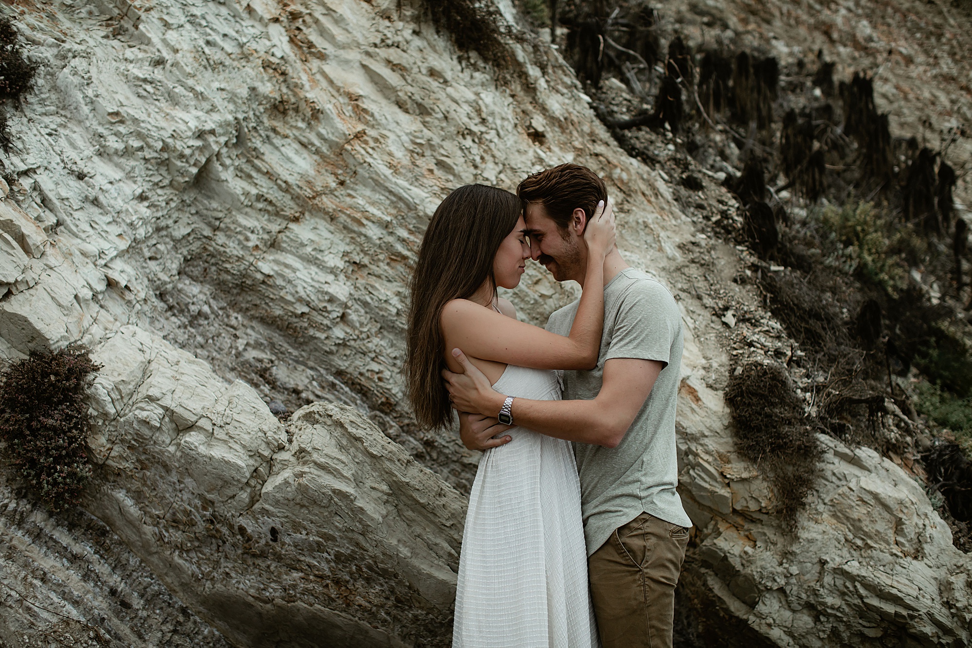 girl and guy touching foreheads point dume engagement session