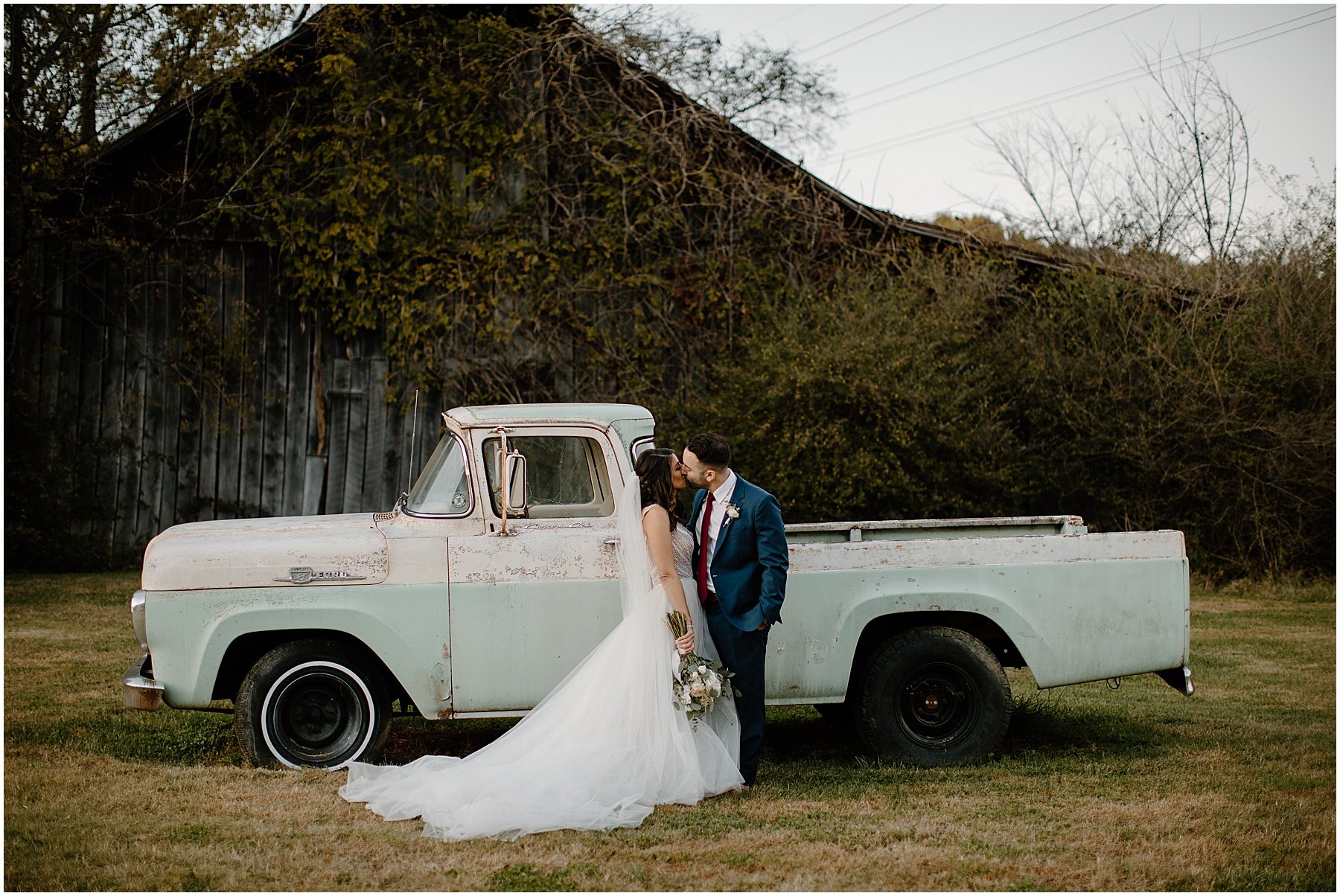 couple kissing in front of vintage truck at drakewood farm in nashville tn 